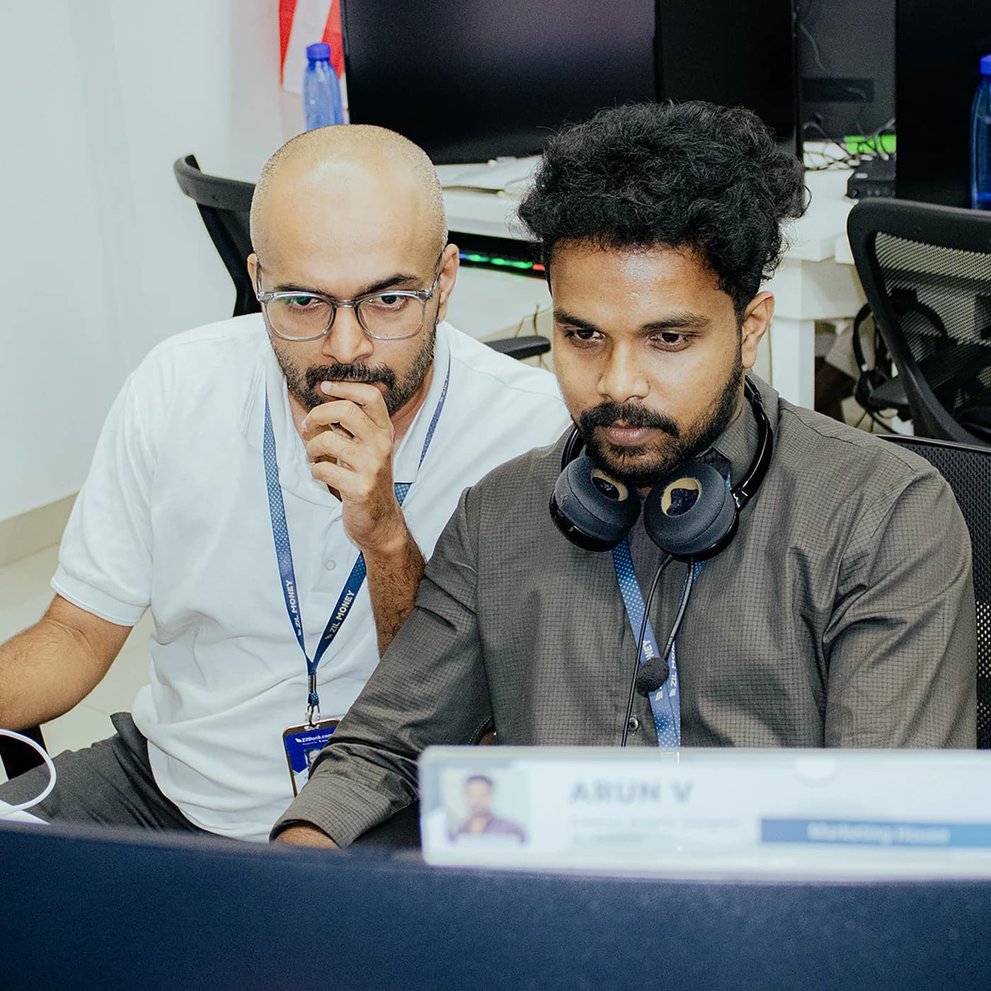 Seyed Marvan reviewing content with a teammate